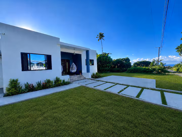 Zephyr Villa front yard — modern bungalow with manicured lawn, Balenbouche, St. Lucia
